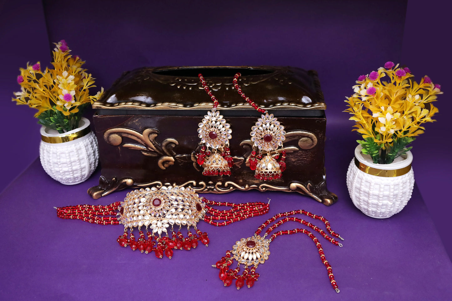 Jewelry set with decorative flowers on a purple background