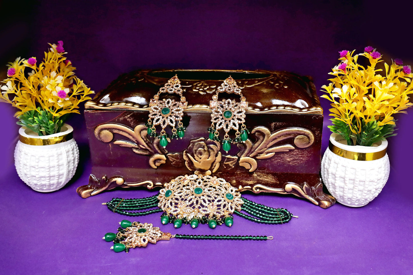 Jewelry set with earrings, necklace, and hair accessories on a purple background with decorative vases.