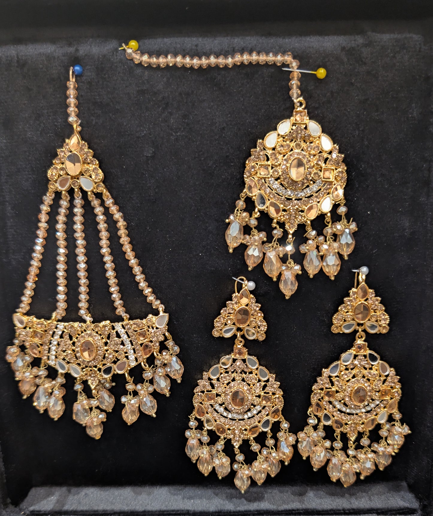 Ear rings and matha patti, hair set in golden color