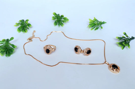 Gold Pendent with black accents on a light blue background with green plants.