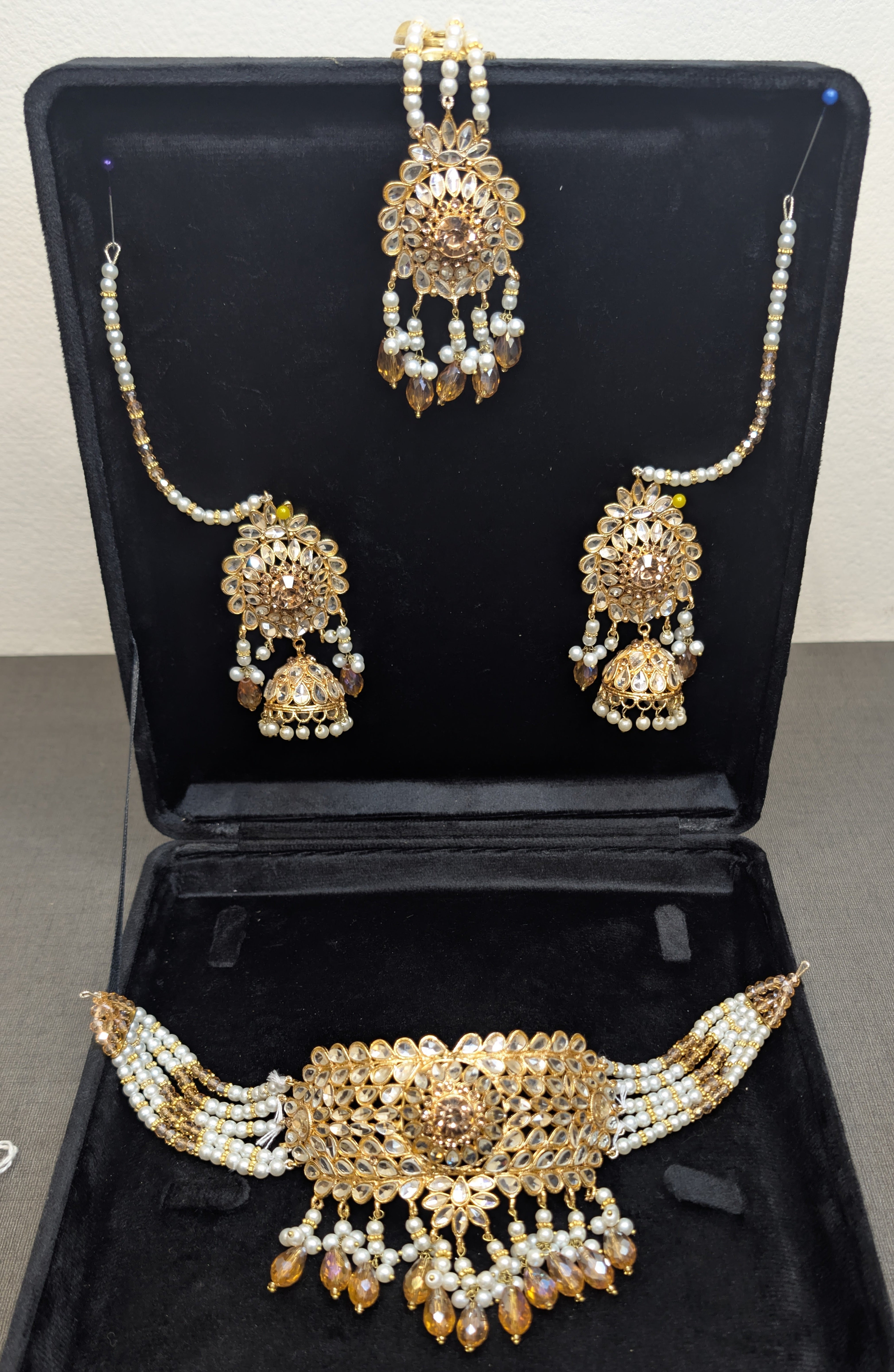 Gold and pearl jewelry set in a black display box