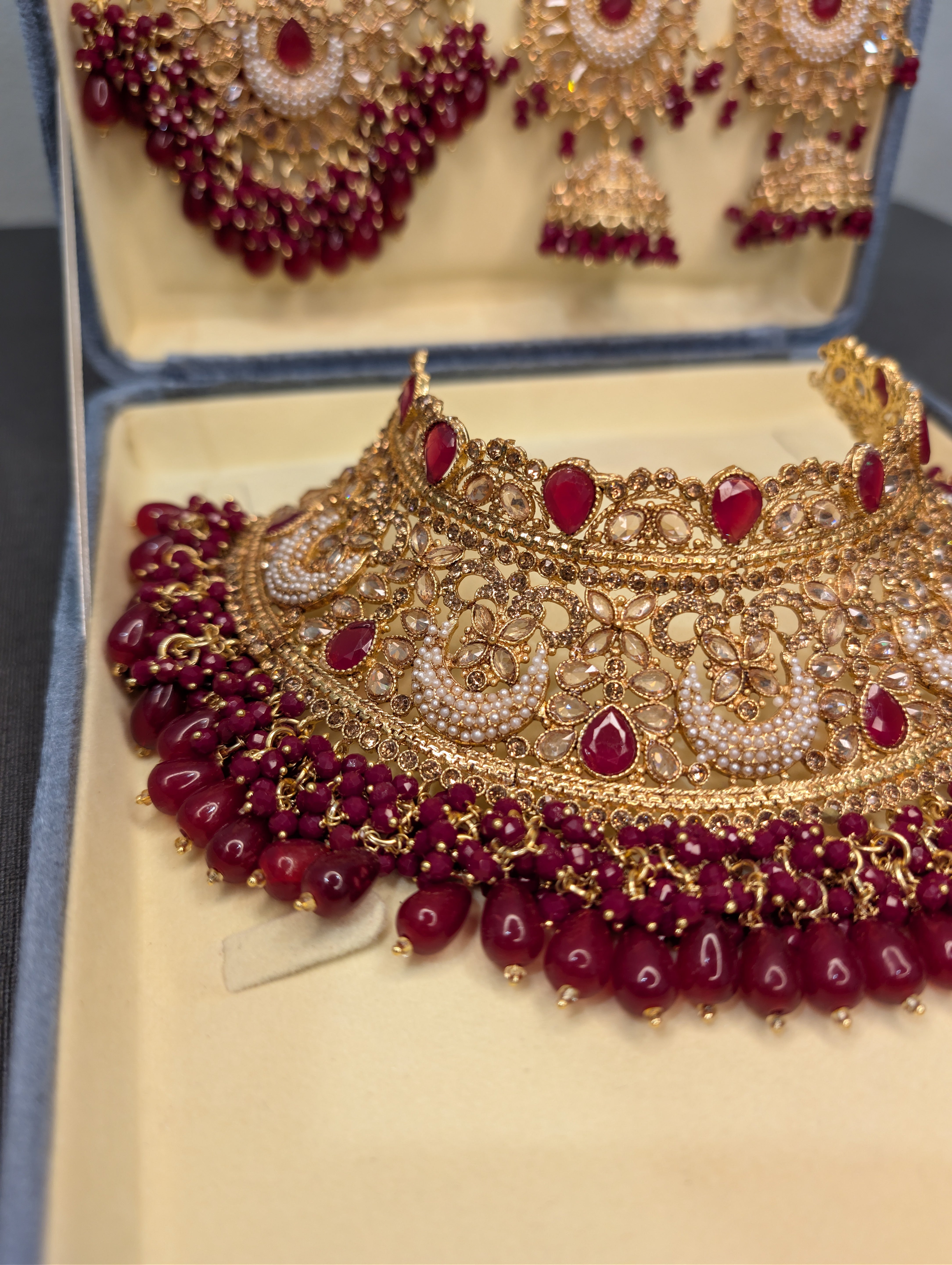 Gold and red jewelry set in an open box