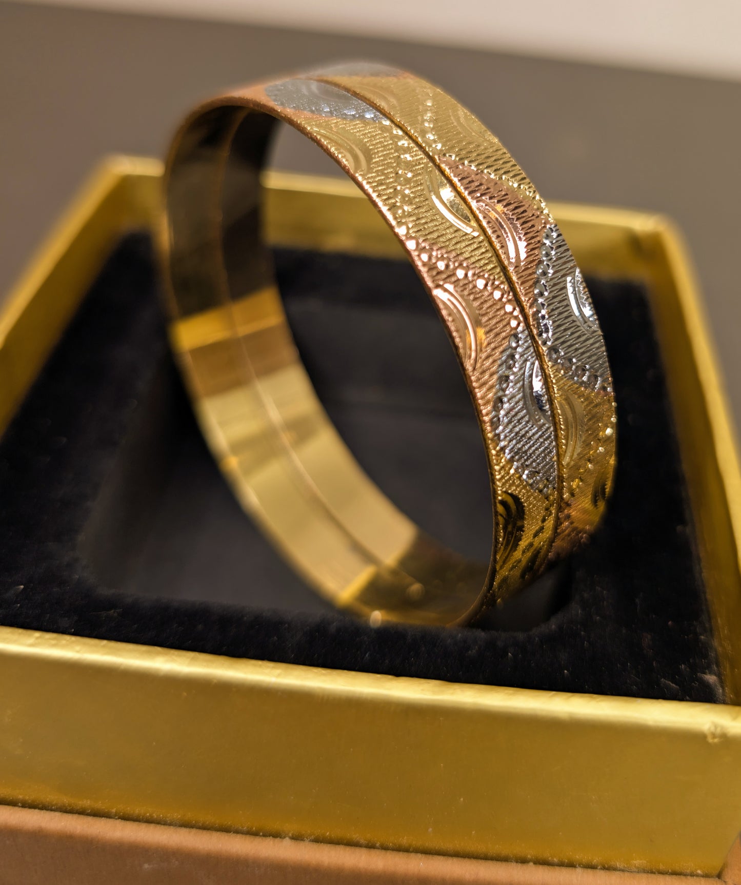 Gold and silver bracelet in a yellow box