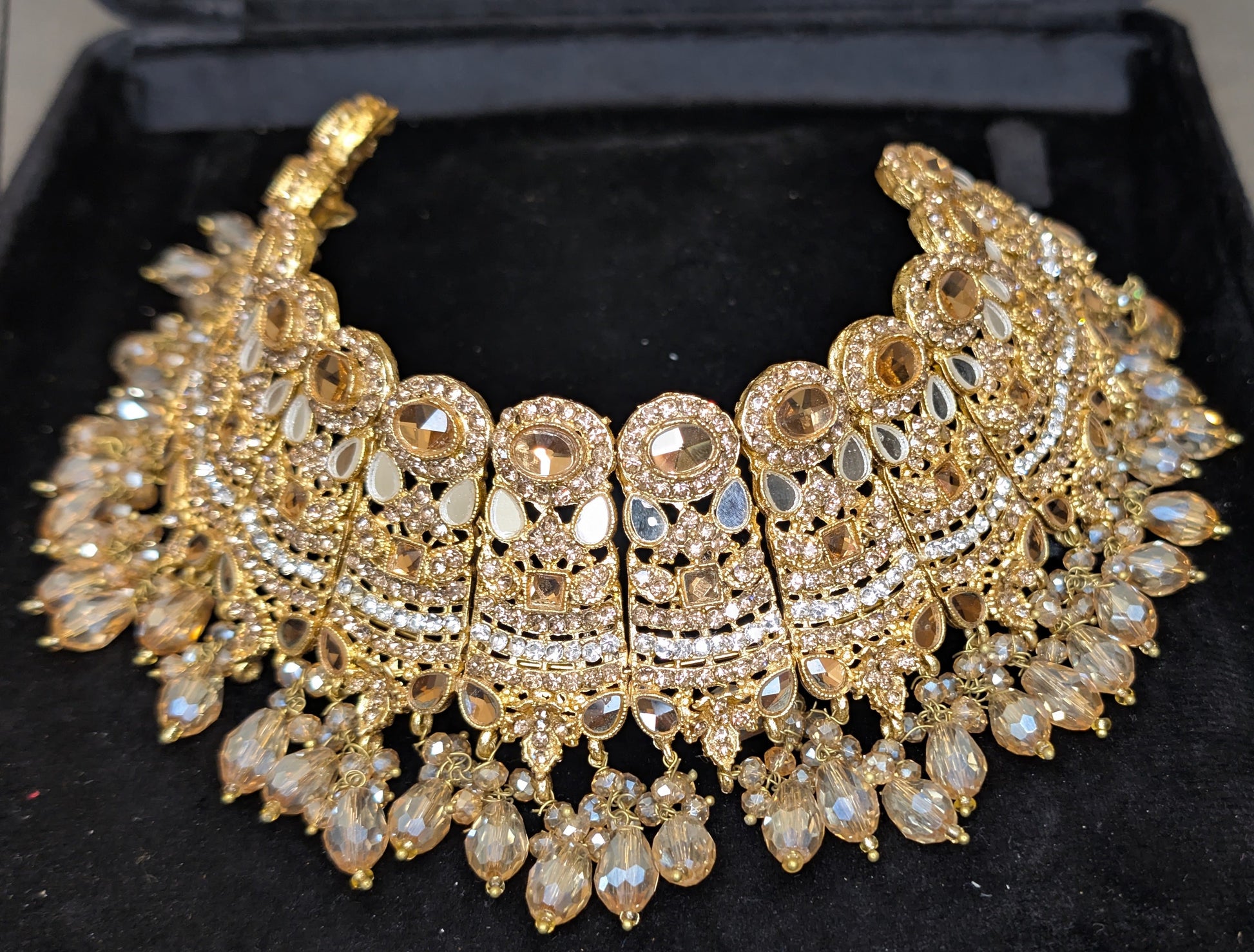 Gold necklace set on a black display box