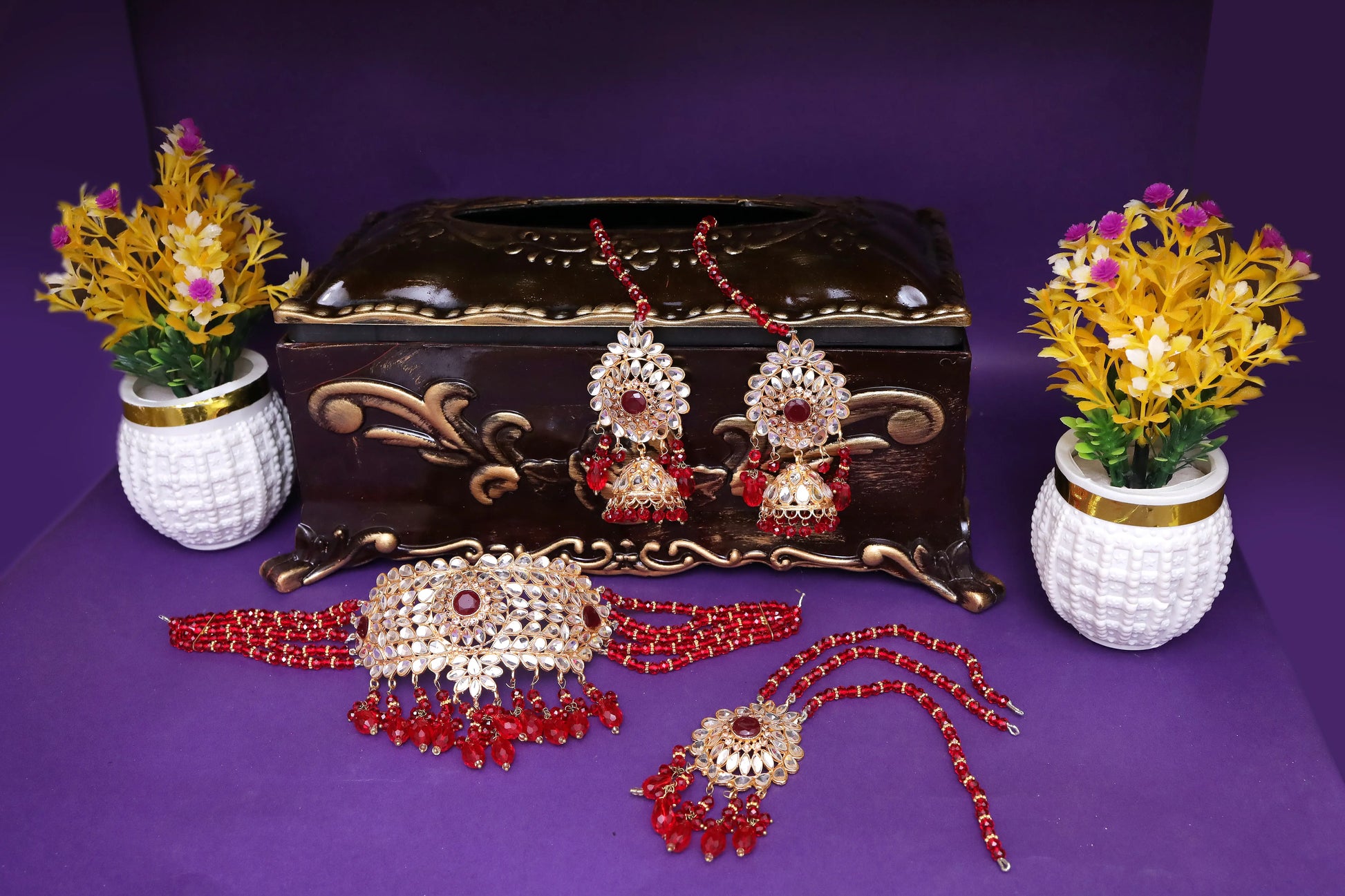 Jewelry set with decorative flowers on a purple background