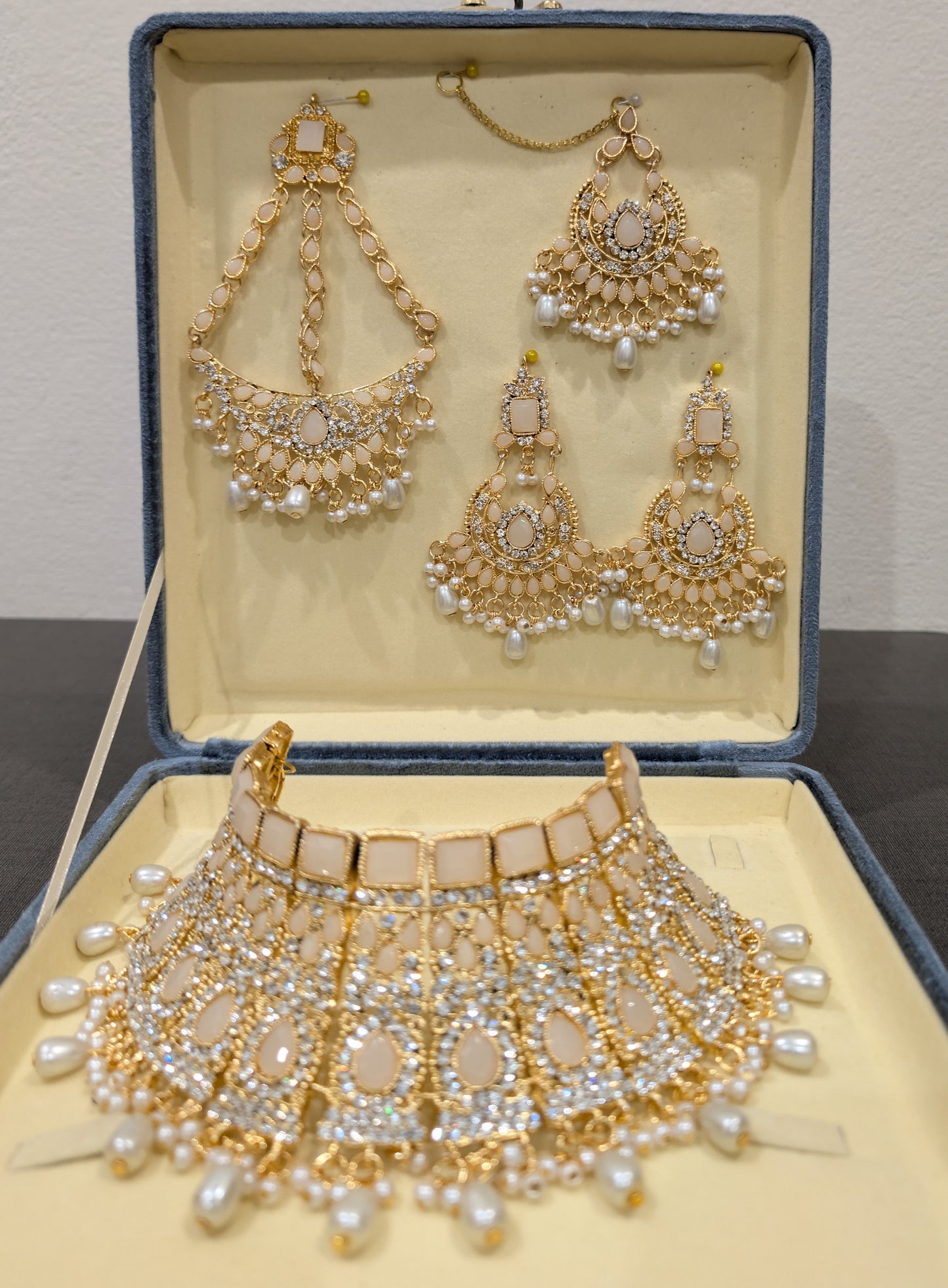 Jewelry set with necklace, earrings, and bracelet in an open jewelry box.