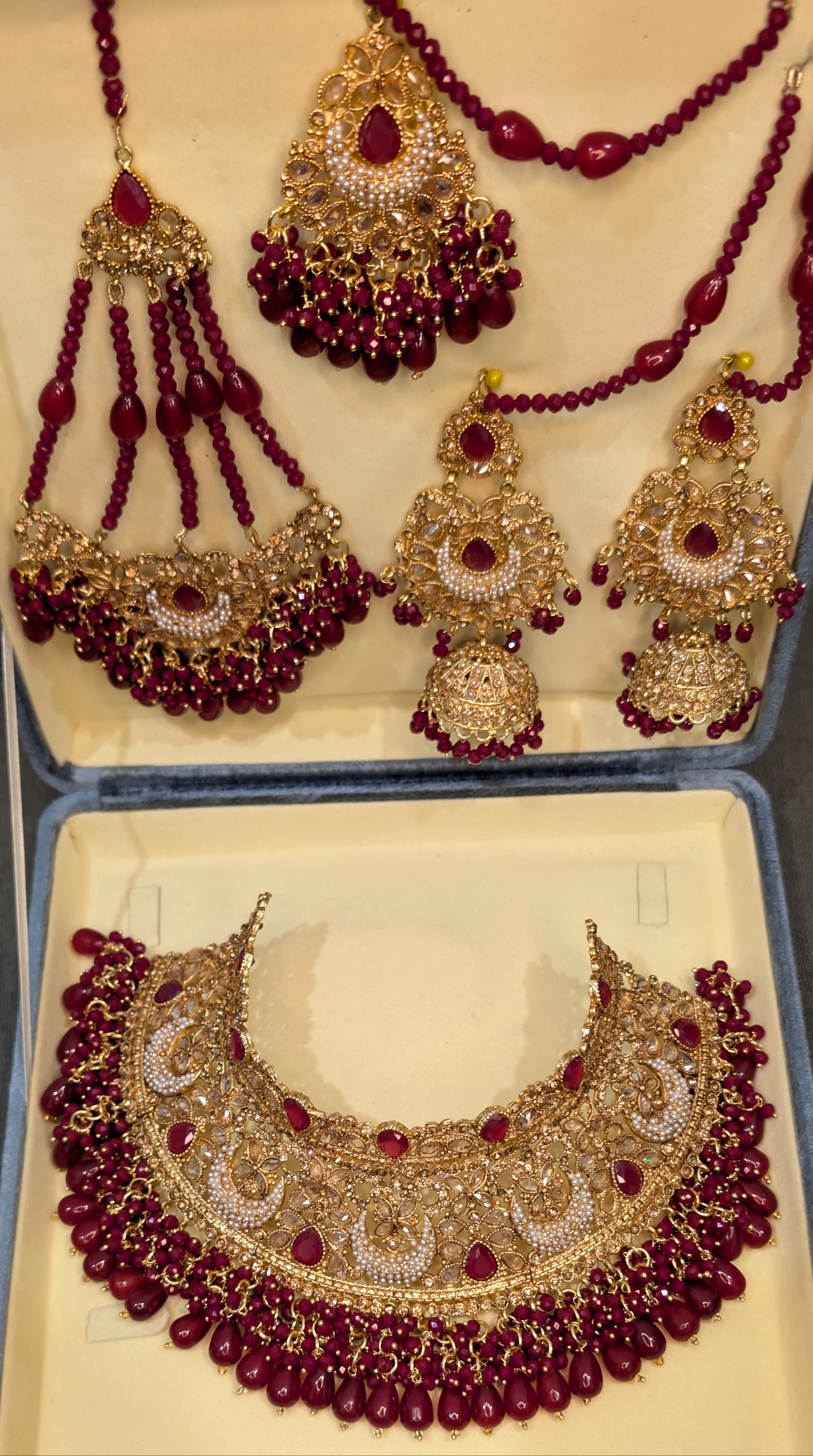 Ornate gold and red jewelry set in a box