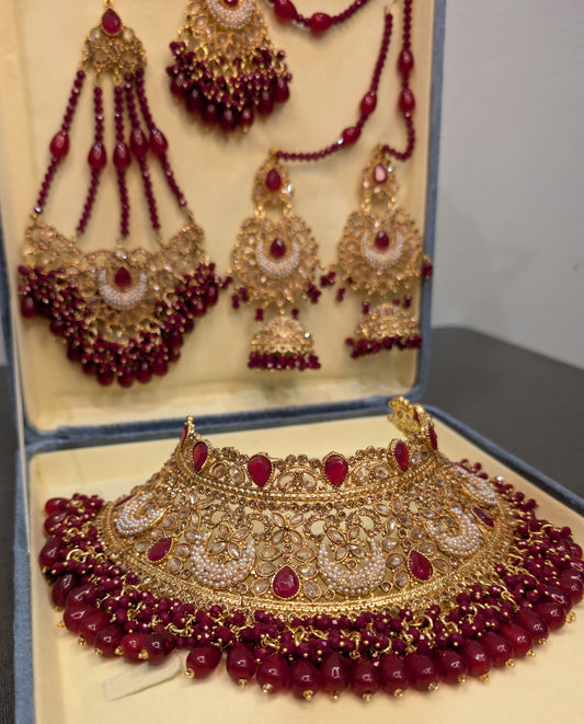 Ornate gold and red jewelry set in a box