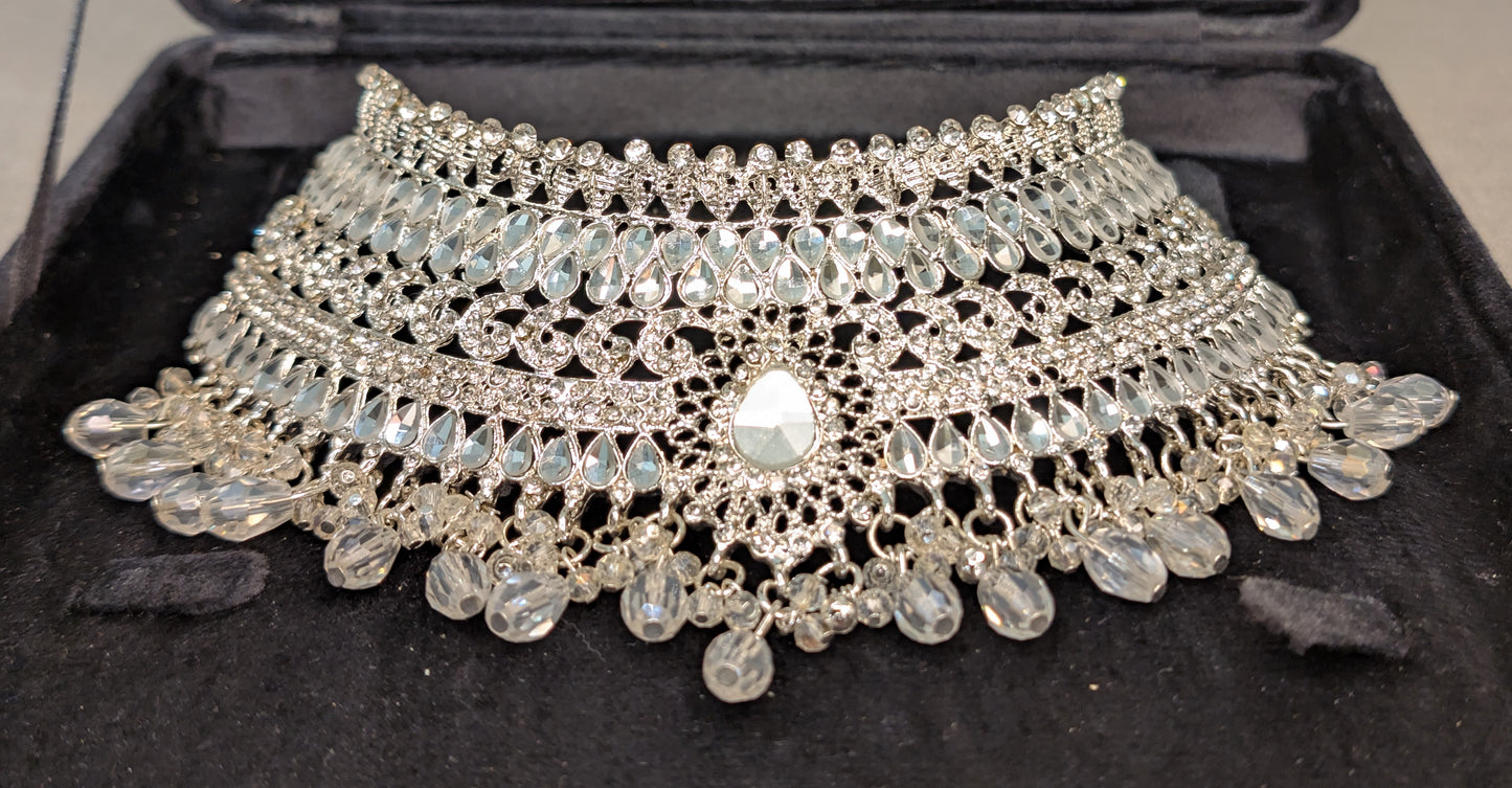 Silver necklace with beads on a black background